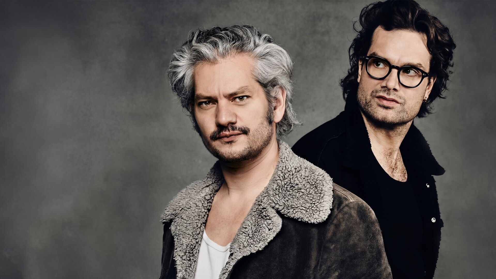 Maarten Heijmans en Xander Vrienten poseren voor een grijze achtergrond